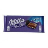Шоколад 100г Milka молочний з кремовою начинкою та шматочками печива Орео
