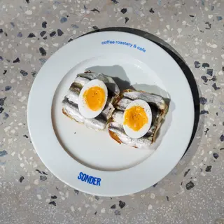 Brioche with sprats and soft-boiled egg