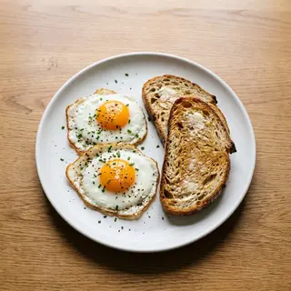 Two Eggs With Two Slices Of Bread