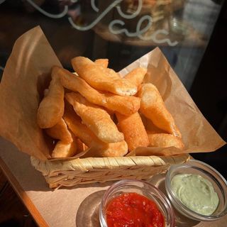 Cesta de pizza frita con sus salsas