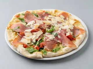 Focaccia Con Jamón, rúcula, queso parmesano y tomate fresco