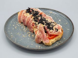 Tosta de jamón ibérico, tomate rosa, virutas foie, polvo de olivas negras