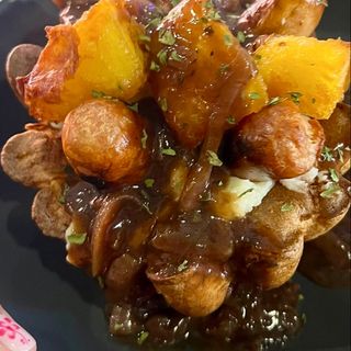 Salchichas y salsa de cebolla, dentro de un pudín de Yorkshire gigante.