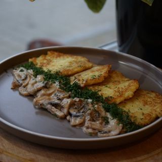 Draniki with mushrooms in sauce