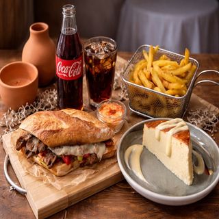 Philly Cheesesteak Sandwich with Fries , San Sebastian Cheesecake and Coca-Cola