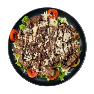 Insalata con hamburger di chianina, scaglie di grana, pomodoro pachino e glassa d’aceto balsamico