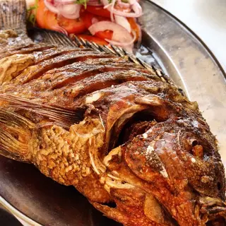 Dry fry tilapia with fries and kachumbari