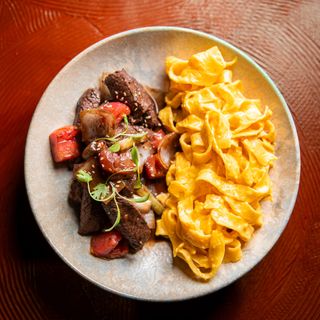 Sauteed lomo with fettuccine a la huancaina