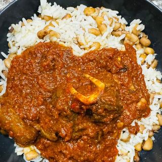 White rice mixed with oloyin beans served with beef 