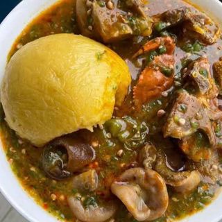 Yellow Eba served with okro mixed with shaki and pomo