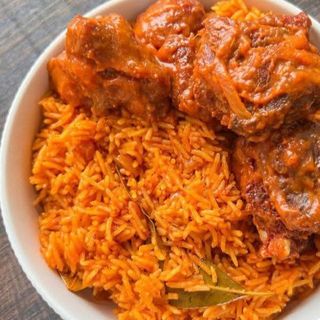 Jollof rice served with peppered Lamb Casserole 