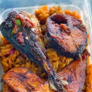 Jollof rice served with titus fish and plantains 