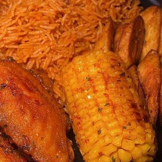Jollof rice, plantains, chicken mixed with boiled sweetcorn