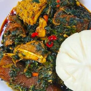 Fufu served with eforiro mixed with assorted meat