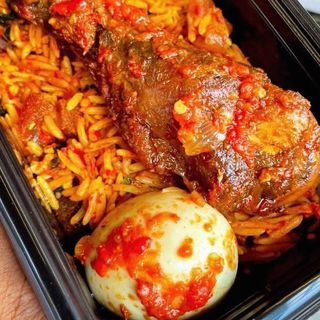 Jollof rice, chicken and boiled egg in spicy Nigerian sauce
