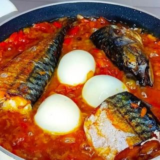 Titus fish mixed with 3 boiled eggs in Nigerian spicy sauce