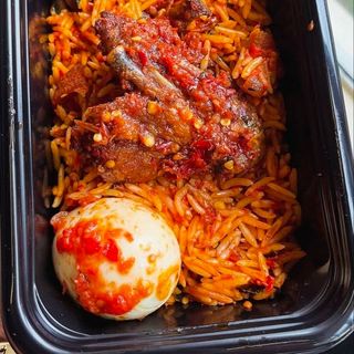 Jollof rice, boiled egg and peppered chicken wings