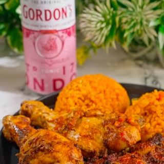 Jollof rice, peppered drumsticks and pink tonic