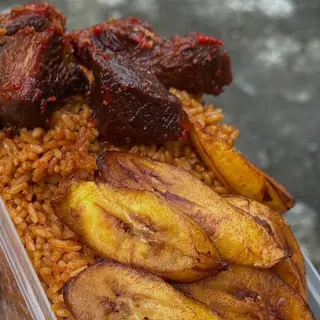 Jollof rice, plantains and peppered beefcubes in naija spicy sauce