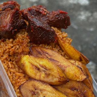 Jollof rice, plantains and peppered beefcubes in naija spicy sauce