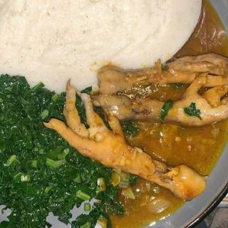 Semolina served with chicken feet and vegetables