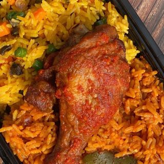 Half Jollof, Half fried rice with peppered turkey drumstick and a can of Palm Wine