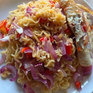 Fried eggs served with noodles stir fried in lots of onions
