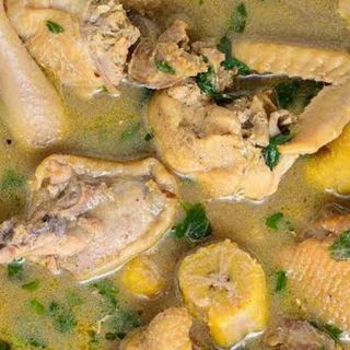 Traditional chicken mixed with boiled plantains peppe soup 