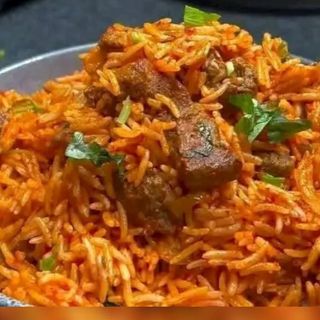 Jollof rice mixed with spicy beef cubes 
