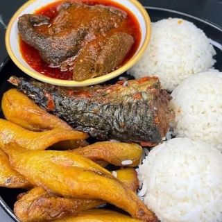White rice, titus fish, plantains and beef sauce on the side