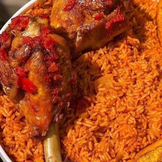 Jollof rice with peppered Turkey drumstick and a can of Palm Wine