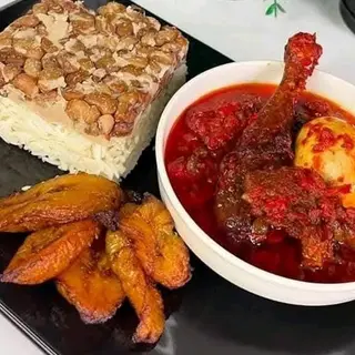 White rice mixed with oloyin beans, fried plantains, chicken mixed with 1 boiled egg