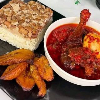 White rice mixed with oloyin beans, fried plantains, chicken mixed with 1 boiled egg 