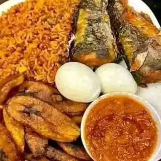 Jollof rice, plantains, titus fish, 2 boiled eggs and sauce