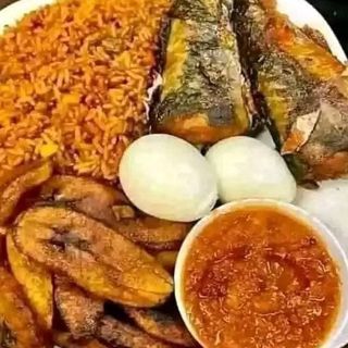 Jollof rice, plantains, titus fish, 2 boiled eggs and sauce 