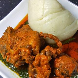 Fufu served with ewedu mixed with goatmeat