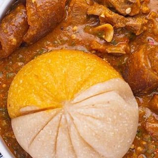 Ogbono mixed with okro and Assorted meat served with half white eba and half yellow Eba 