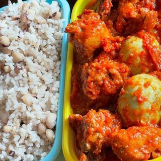 White rice mixed with beans served with beef and 2 boiled eggs 