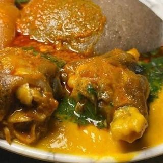 Amala served with ewedu and gbegiri mixed with goatmeat