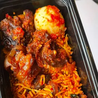 Jollof rice, boiled egg and peppered beef