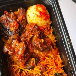 Jollof rice, boiled egg and peppered beef