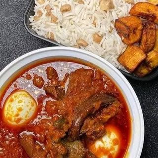 White rice mixed with oloyin beans, plantains, 2 boiled eggs mixed in spicybeef stew 