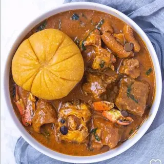 Yellow Eba served with ogbono mixed with Assorted meat and chicken