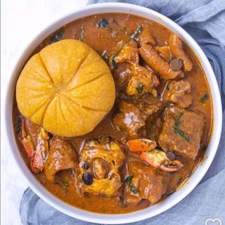 Yellow Eba served with ogbono mixed with Assorted meat and chicken
