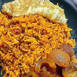 Jollof rice, fried egg and pomo