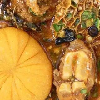 Yellow Eba served with okro mixed with cowleg and shaki