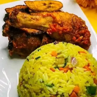 Fried Rice served with plantains and drumstick