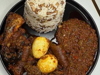 White rice mixed with oloyin beans served with 2 boiled eggs, pomo and titus fish