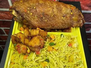 Turkey wing served with fried rice and plantains