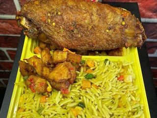 Turkey wing served with fried rice and plantains